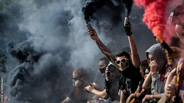 Detroit City fans celebrating with pyrotechnic flares