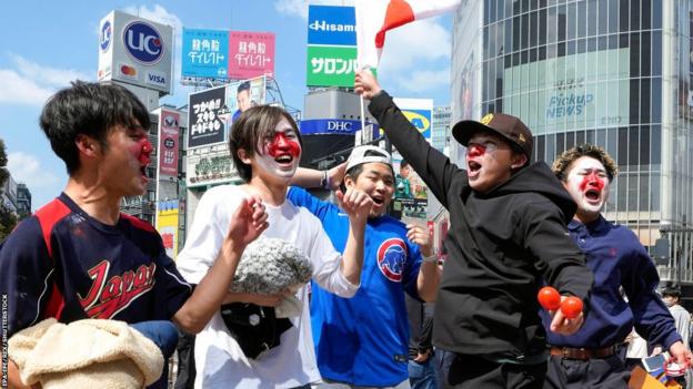 Fans celebrate Japan's victory at the World Baseball Classic in Tokyo