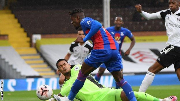 Crystal Palace's Wilfried Zaha has a shot in their Premier League game against Fulham