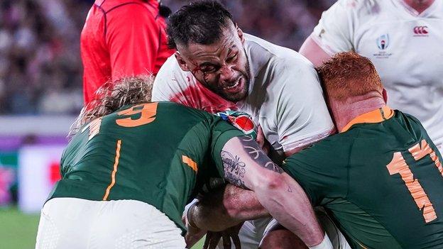 England's powerful number eight Billy Vunipola tries to break a tackle against South Africa in the 2019 World Cup final