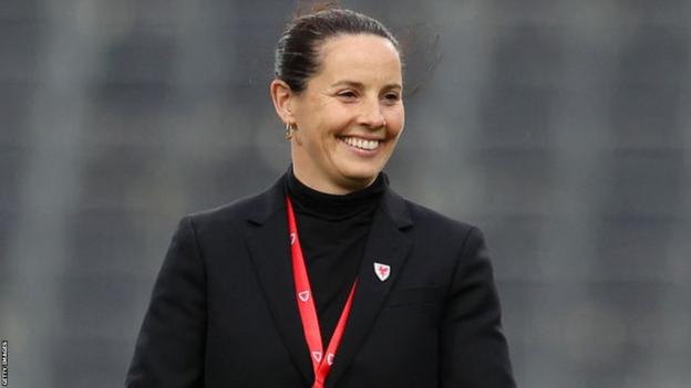Wales manager Rhian Wilkinson smiles ahead of kick off