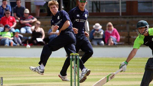 Scotland's Gavin Main attempts to get a run out in an international T20 game against Ireland in 2015