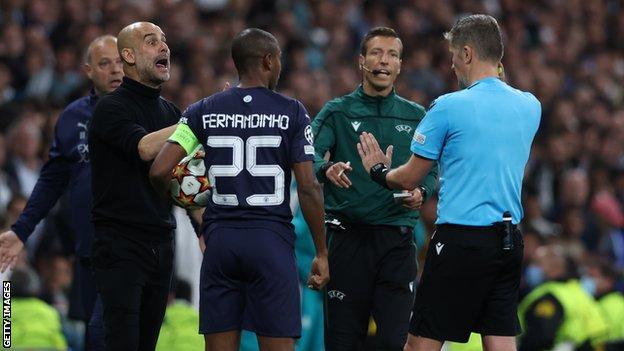 Man City boss Pep Guardiola with referee Daniele Orsato