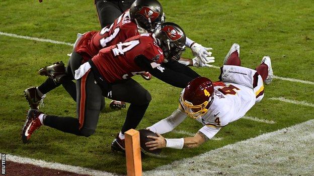 Washington Football Team quarterback Taylor Heinicke scores a touchdown against the Tampa Bay Buccaneers