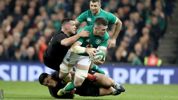 Peter O'Mahony is tackled by New Zealand's Ryan Crotty and Codie Taylor