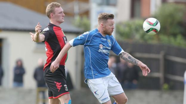 Steven Gordon and Ryan Harpur keep their eyes on the ball during Glentoran's win over Dungannon Swifts