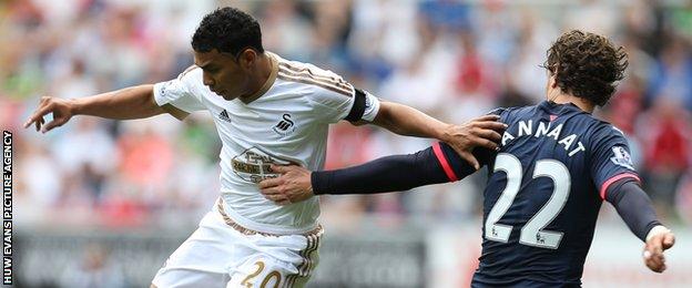 Newcastle's Daryl Janmaat (right) fouls Jefferson Montero of Swansea