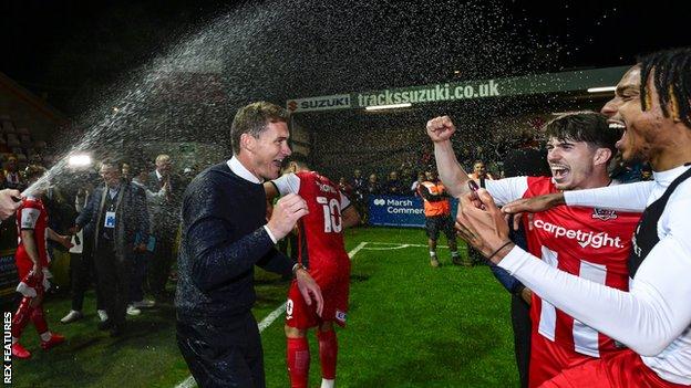 Exeter City manager Matt Taylor celebrates