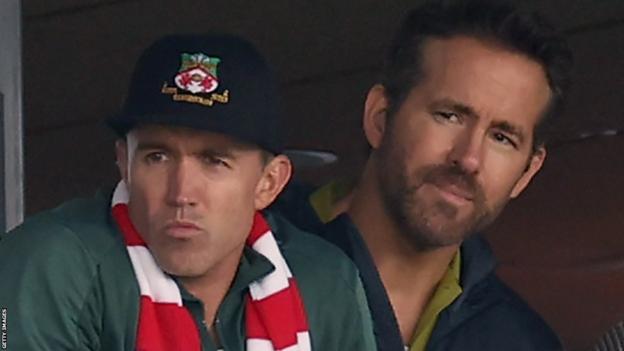 Rob McElhenney and Ryan Reynolds watch Wrexham play Manchester United