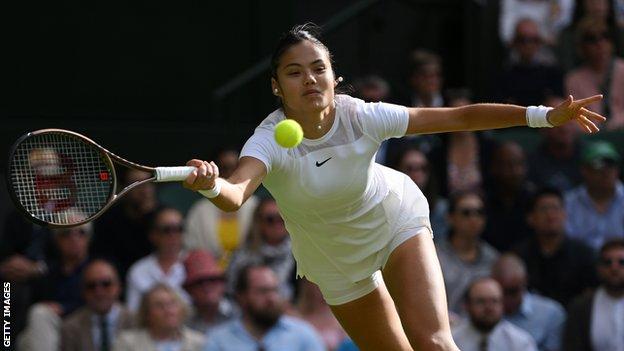 Emma Raducanu stretches for a ball in her Wimbledon second-round match against Caroline Garcia