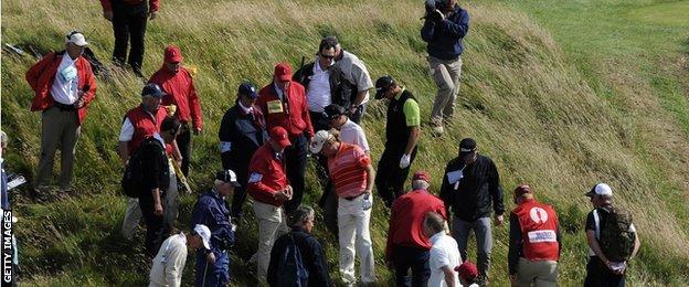 Miguel Angel Jimenez and Retief Goosen search for a ball at the Open Championship, 2009