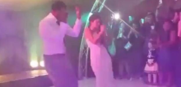 Leroy Fer and his wife dance at their wedding