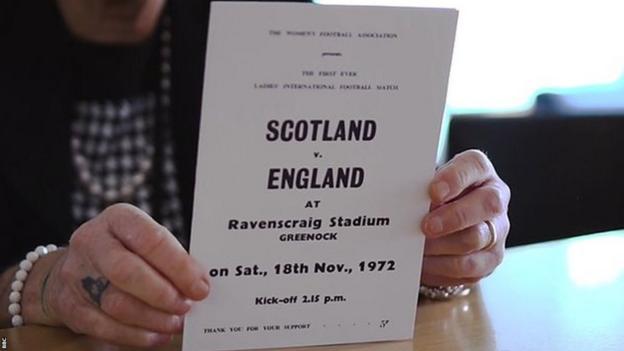 Rose Reilly holding an advert for the match