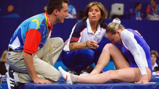 Great Britain's Annika Reeder's grimaces after suffering an injury during the Sydney 2000 all-around final
