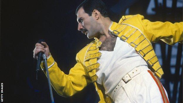 Freddie Mercury performing on stage