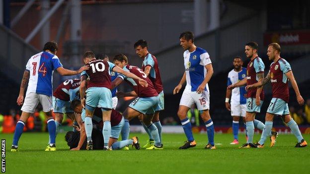 A spectator confronts Burnley players at Ewood Park