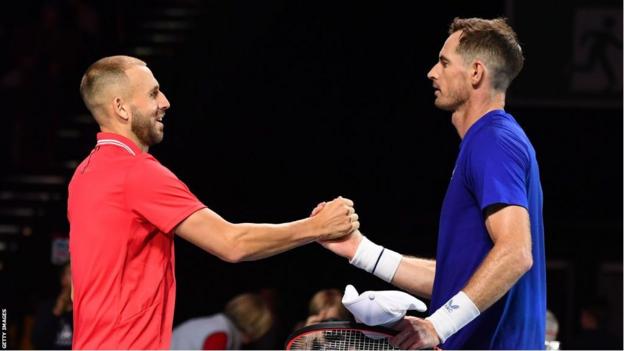 Dan Evans and Andy Murray shake hands at the net