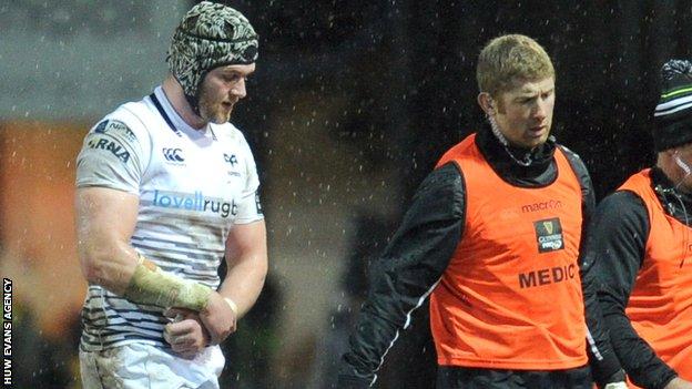 Dan Lydiate is substituted clutching his arm during the Ospreys' game against the Dragons