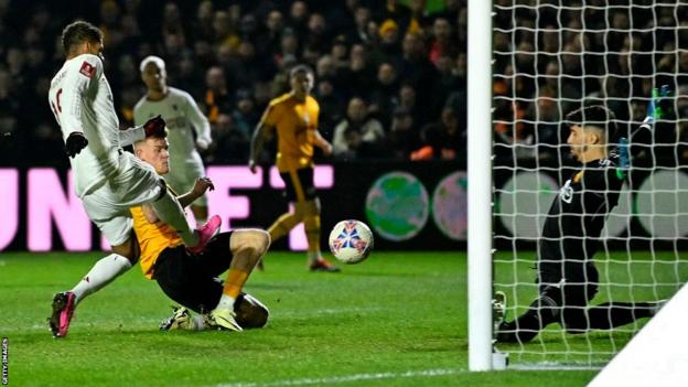 Will Evans scores against Manchester United for Newport.