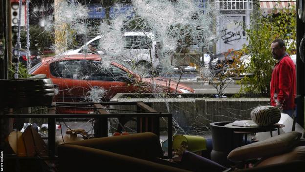 The smashed window of a business in Brussels after