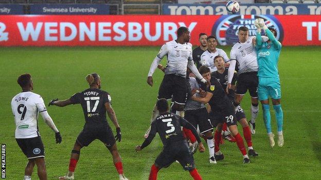 Jake Bidwell rises with David Raya but both players failed to make contact as Conor Hourihane's free-kick sailed into the net