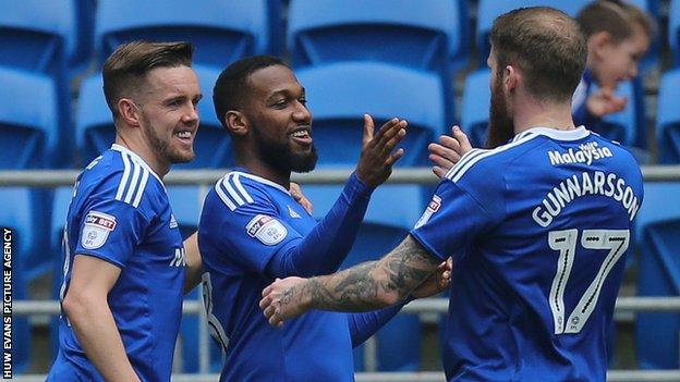 Junior Hoilett celebrates with Craig Noone and Aron Gunnarsson after scoring Cardiff's second goal