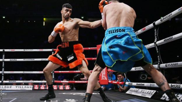 Adam Azim aims a punch at his opponent