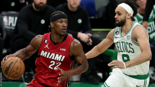Miami Heat forward Jimmy Butler dribbles against Boston Celtics guard Derrick White during Game 1 of the NBA Eastern Conference Finals in 2023