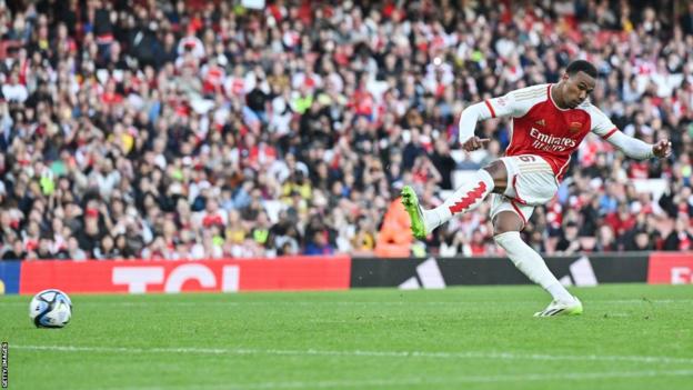 Arsenal defender Gabriel kicks a penalty towards goal