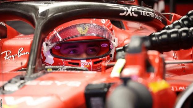 Charles Leclerc sits in his car in the Ferrari garage