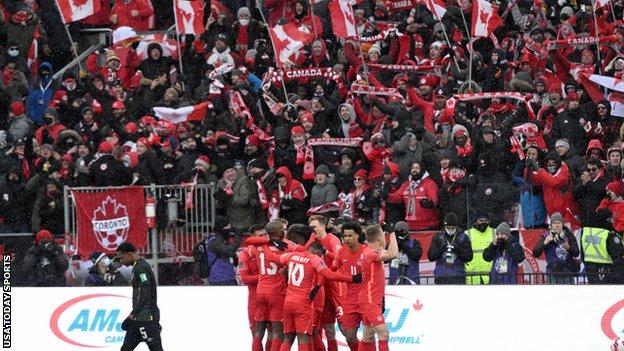 Canadian players celebrate in front of their fans