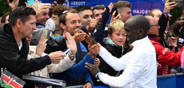 Eliud Kipchoge greets fans after his world record marathon time in Berlin