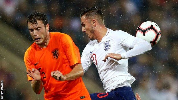 Thomas Ouwejan of the Netherlands compete for the ball with James Maddison of England