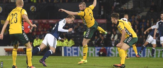 Leigh Griffiths send a header straight at the Lithuania keeper