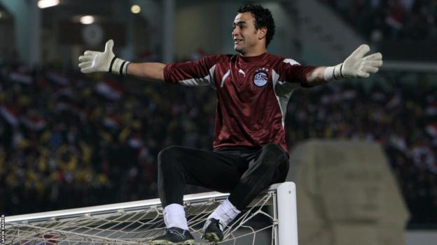 Egypt goalkeeper Essam El-Hadary celebrates while sitting on the top of a crossbar after winning the 2006 Africa Cup of Nations final
