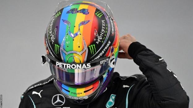 Mercedes' British driver Lewis Hamilton wears a rainbow helmet during practice sessions of the Formula One Saudi Arabian Grand Prix at the Jeddah Corniche Circuit in Jeddah on December 3, 2021.