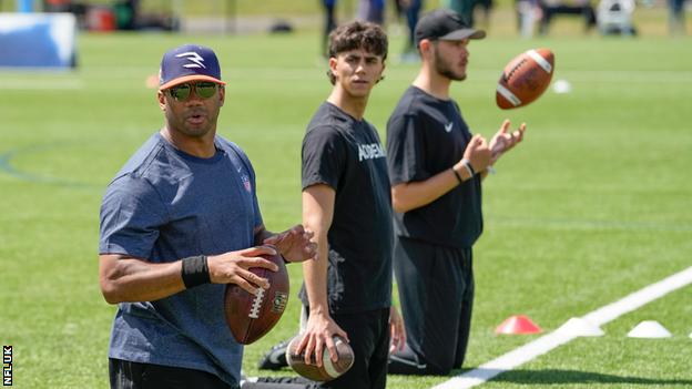 Russell Wilson speaking to NFL Academy students