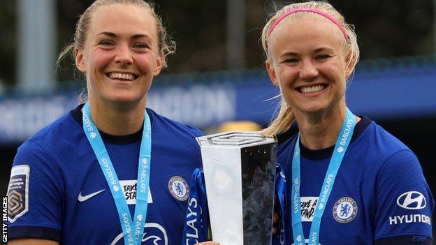 Chelsea team-mates Magdalena Eriksson and Pernille Harder lift the Women's Super League trophy