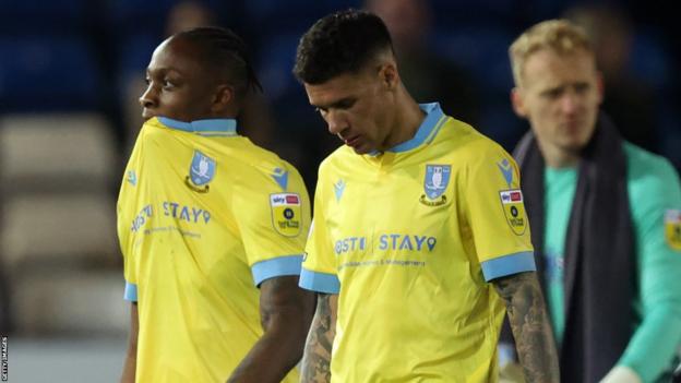 Sheffield Wednesday players leave the field dejected