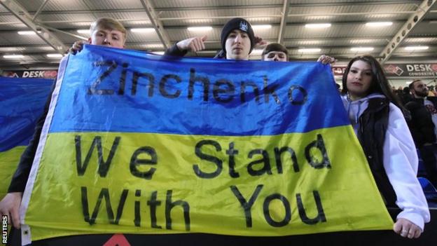 Fans with a banner in support of Oleksandr Zinchenko before kick-off