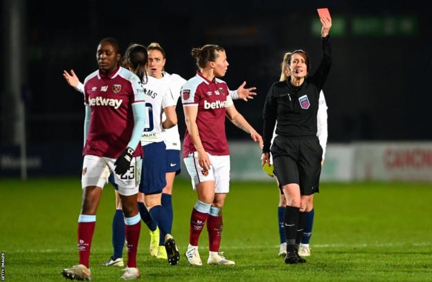 Amy Fearns shows a red card to Hawa Cissoko of West Ham during the Women's Super League match between Tottenham Hotspur and West Ham