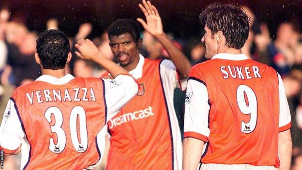 Nwankwo Kanu and his Arsenal team-mates after his treble against Chelsea