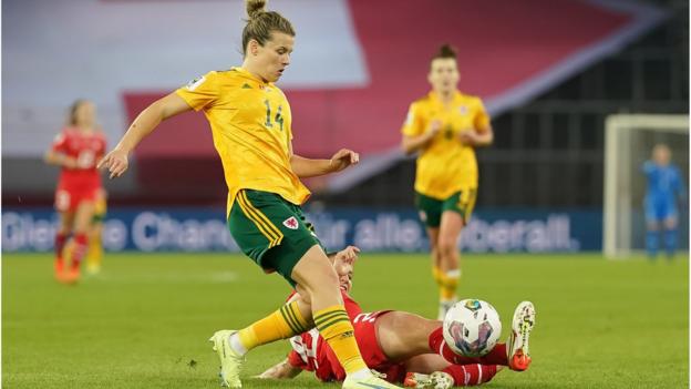 Hayley Ladd of Wales is tackled by Fabienne Humm of Switzerland during the 2023 FIFA Women's World Cup play-off