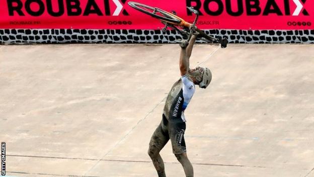 Sonny Colbrelli lifts his bike above his head