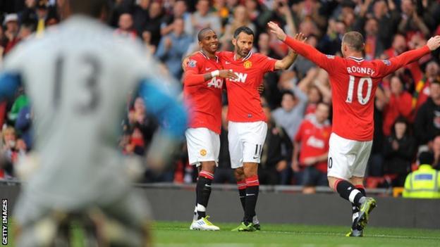 Manchester United's players celebrate scoring against Arsenal at Old Trafford in 2011