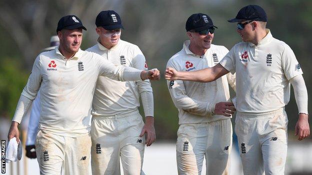 England players (from left to right) Matt Parkinson, Ollie Pope, Dom Bess and Sam Curran congratulate each other as they walk off after day two of a warm-up match in Sri Lanka