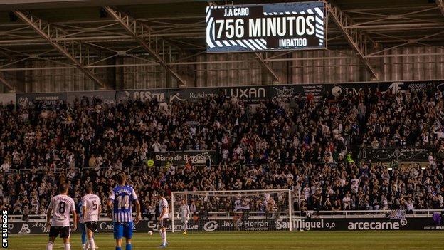 The Burgos fans applaud goalkeeper Jose Antonio Caro as he sets a Spanish record for minutes without conceding at the start of a season