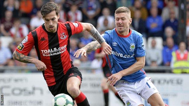 Declan Caddell and Daniel Kearns in action during Linfield's 2-0 win at Crusaders