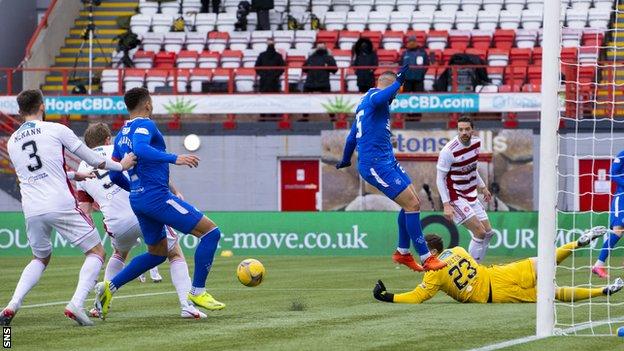 Borna Barisic's cross deflects off Brian Easton (second left) to give Rangers a late lead