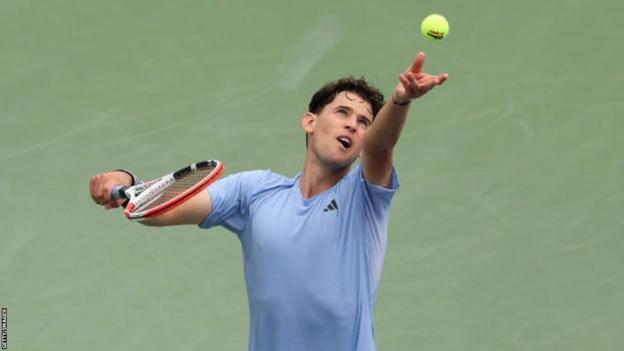 Dominic Thiem throws the ball to serve